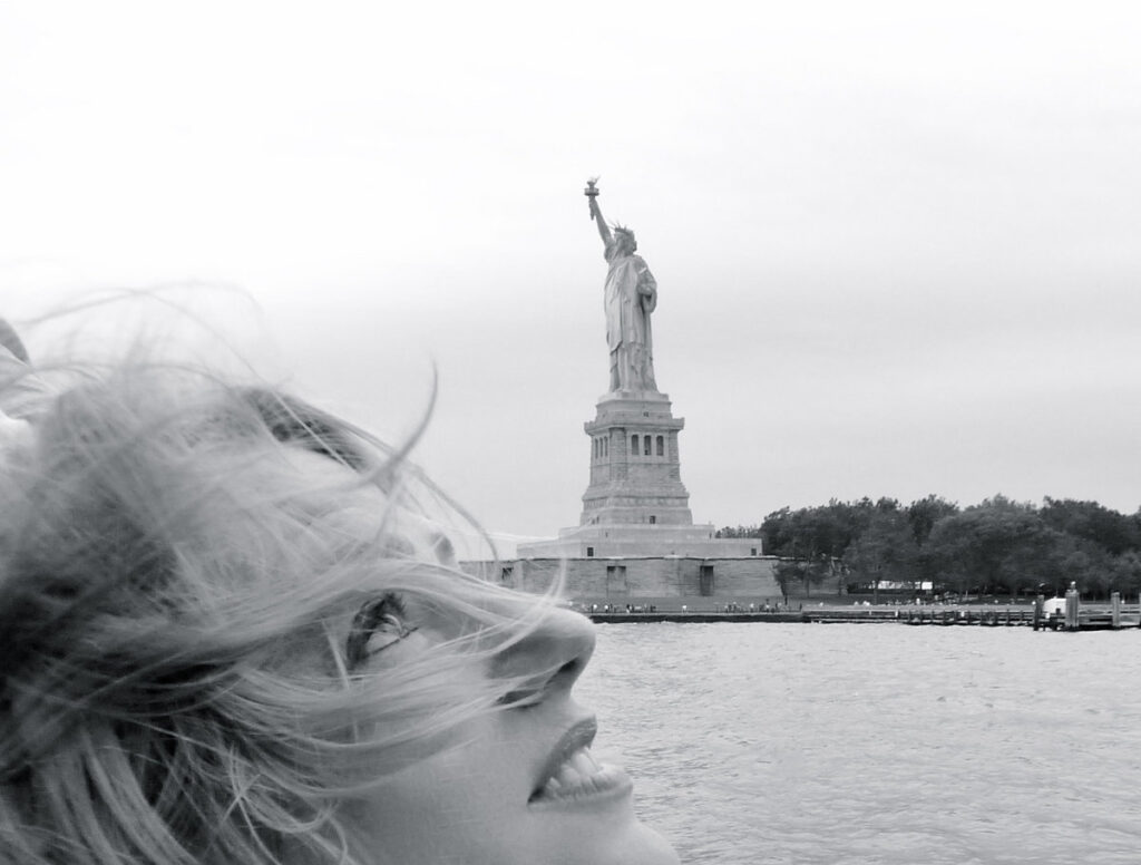 Rebecca Barnard in New York City, with the Statue of Liberty in the background